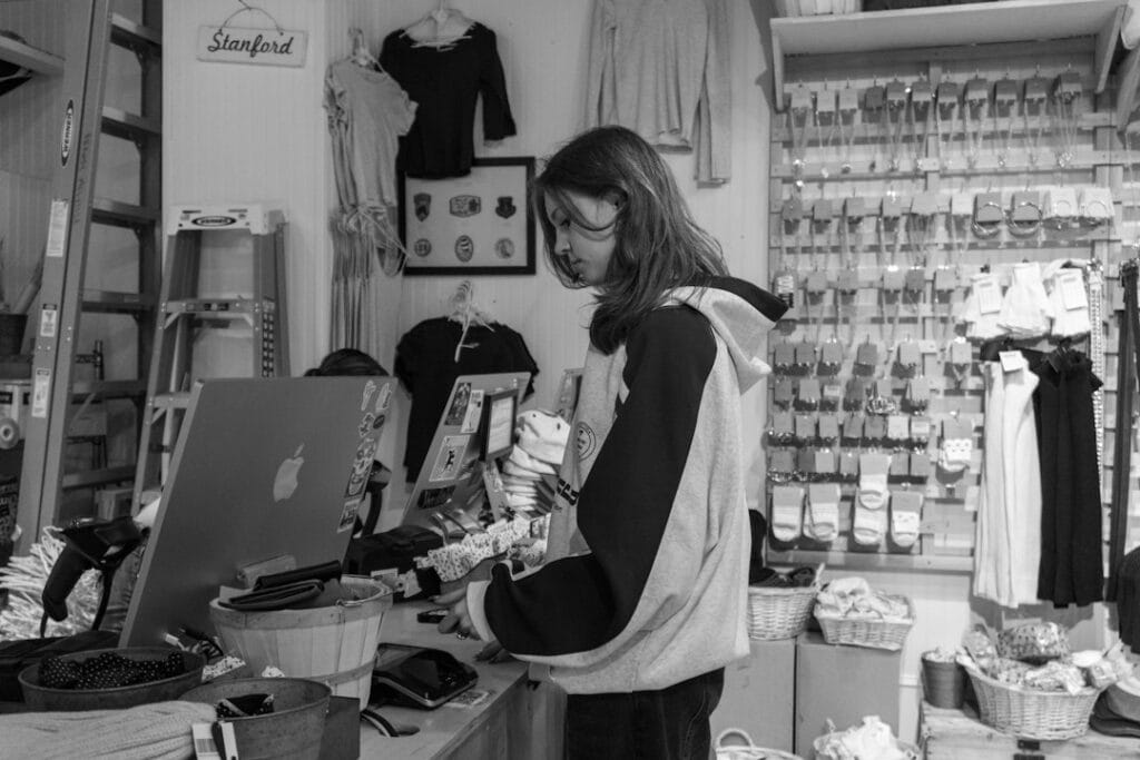 Local shop owner at her store counter working through a Google Business Profile optimization checklist