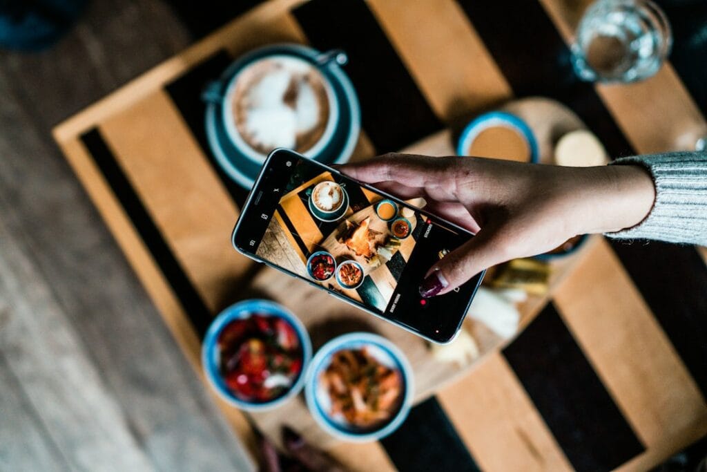 Diner photographing a plated dish for Instagram marketing for restaurants