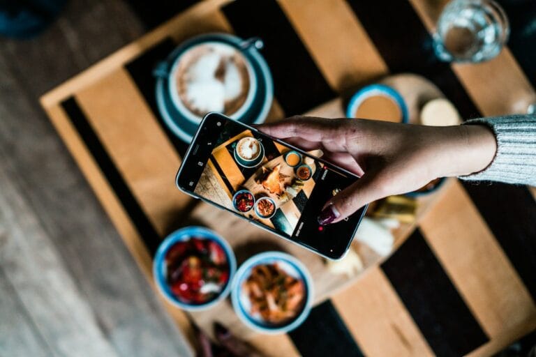 Diner photographing a plated dish for Instagram marketing for restaurants