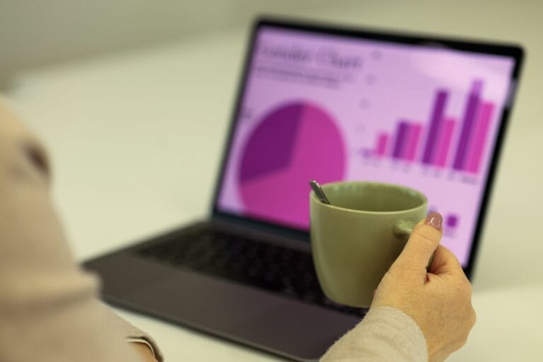 Business owner reviewing SEO cost in Mumbai and website analytics charts on a laptop